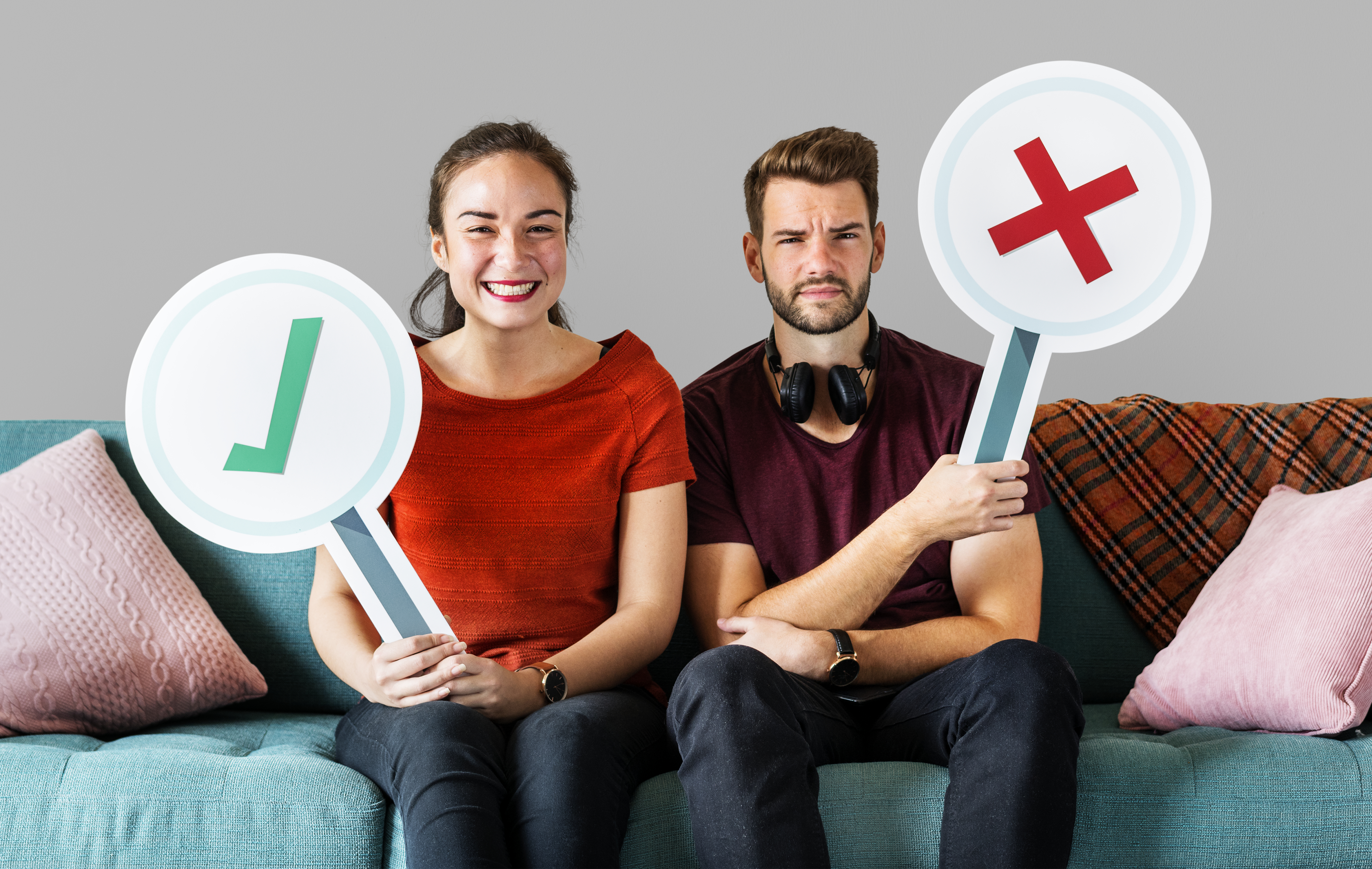 cheerful-couple-holding-vote-icon-sitting-couch.jpg